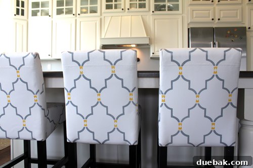 Finished custom stenciled leather bar stools in a stylish kitchen setting