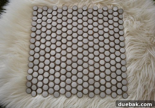 Our Kitchen's Penny Tile Backsplash The Perfect Pick 11 Tile sample on ottoman
