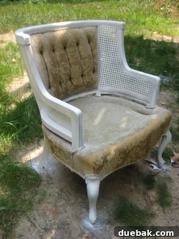 Chair frame in progress, showing the wood after being spray primed and painted a bright white.