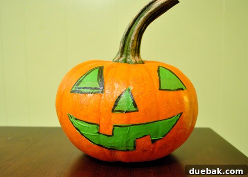 Jack-o-lantern taped pumpkin, awaiting paint