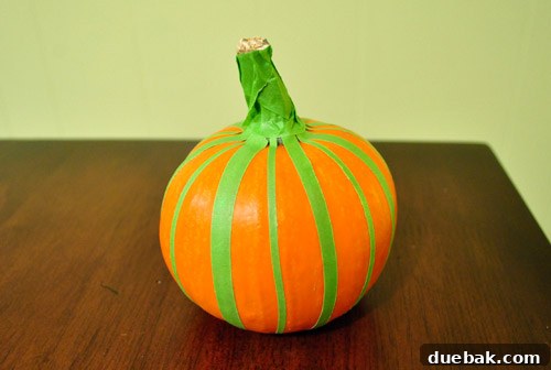 Small pumpkin with horizontal painter's tape stripes