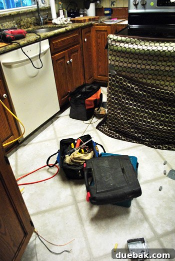 Electrician working on wiring in the kitchen