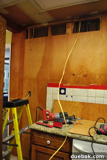 Close-up of exposed electrical wires in kitchen wall