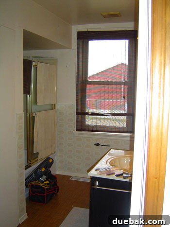 Graphite Gray Bathroom Renovation 2 Dated 1950s bathroom before renovation, showing original fixtures and limited space.