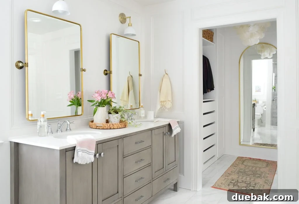 Luxurious marble bathroom featuring a traditional runner rug, adding elegance and warmth to the sophisticated space.