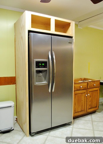 DIY Built-In Refrigerator Installation 16 The newly installed built-in refrigerator enclosure, unfinished but transforming the kitchen's look