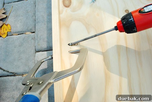 DIY Built-In Refrigerator Installation 7 Pine trim being clamped and screwed to plywood, using a Kreg jig for pocket holes