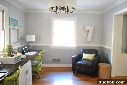 The large industrial number '7' prominently displayed in a home office setting, creating a unique focal point next to a modern chair.
