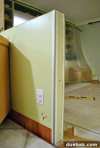 Metal drywall corner strip applied to the half-wall