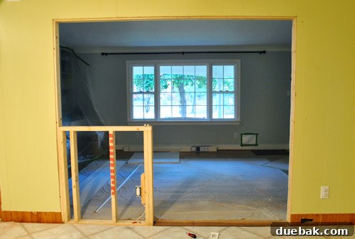 Drywall installation in progress around the new opening