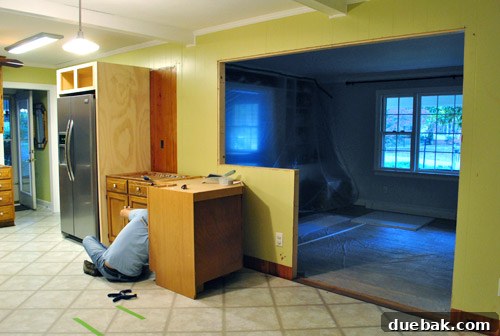 Cabinet temporarily placed against the half-wall before drywalling