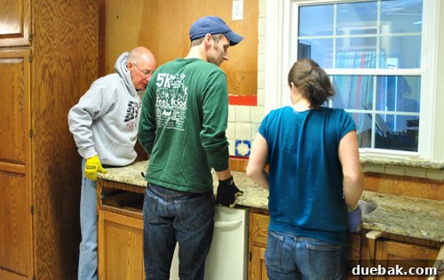 Family struggling with heavy granite slab