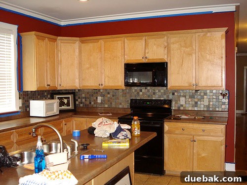 Kitchen Island Makeover with Brackets 2 Before kitchen renovation showing a typical builder-grade kitchen with original cabinets and layout