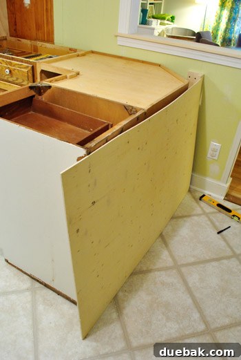 Optimize Your Kitchen: Filling Stove-Side Cabinet Gaps 17 Installing the plywood panel on the back of the peninsula