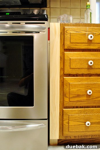 Optimize Your Kitchen: Filling Stove-Side Cabinet Gaps 9 Close-up of remaining small gap after initial fillers