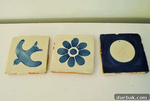 Three salvaged blue kitchen tiles, possibly for coasters