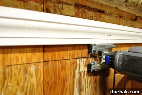 Using a makeshift wood guide to keep Dremel cuts straight