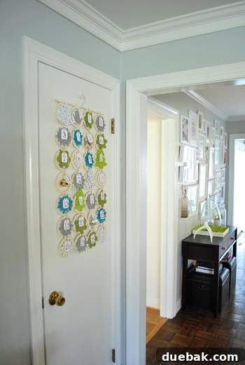 Handmade Advent Calendar hanging on a door, seen from an adult's perspective.