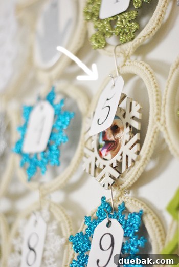 Close-up of a snowflake frame ornament with a picture of a dog inside.