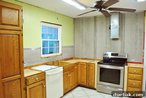 Freshly painted kitchen walls and ceiling showing improvement