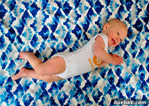 Baby Clara on the same fabric used for the stool, resembling water
