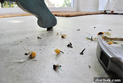Removing old nails from the stool top with a hammer