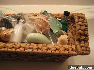Bathroom toiletries neatly arranged in a decorative basket with seashells, perfect for coastal decor