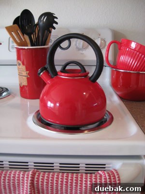 Kitchen featuring cheerful red appliances including a coffee maker, toaster, and tea kettle