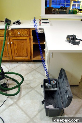 Installer using specialized heating tools to create seamless Corian countertop joints during installation.