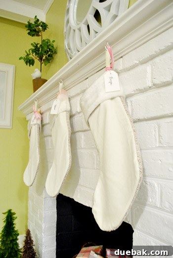 Close-up of three Christmas stockings hanging on a mantel.