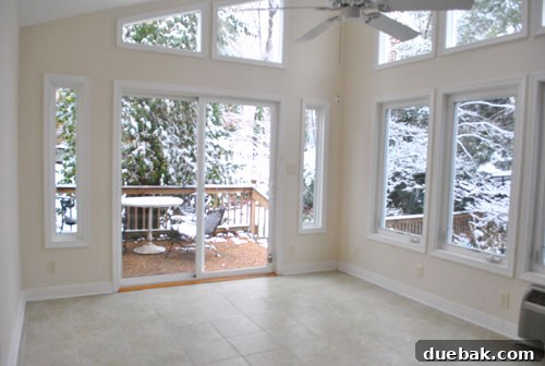 Empty sunroom in the new house, filled with natural light, awaiting its purpose.