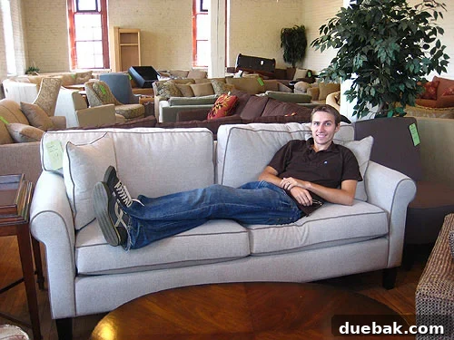 Man sitting on an eco-friendly sofa at Green Front Furniture