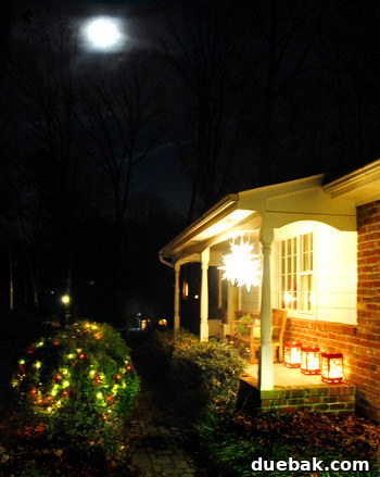 Our Dazzling Outdoor Christmas Display 8 Three over-sized red metal lanterns from Ikea, artfully arranged on the porch, each filled with glowing white lights.