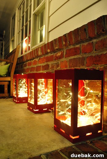 Our Dazzling Outdoor Christmas Display 9 A close-up shot of one of the red metal lanterns, showcasing the abundance of white string lights stuffed inside for a brilliant glowing effect.