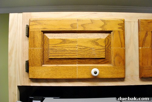 Newly assembled cabinet door installed, showing a surprisingly good fit.