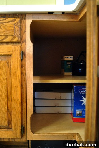 Close-up of cabinet frame with hinge notches, requiring repair before door installation.