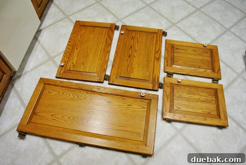 Five surplus cabinet doors identified for repurposing in the kitchen renovation.