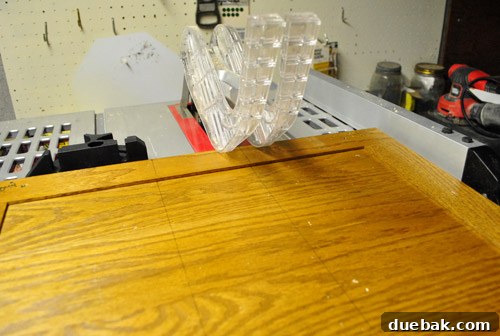 Table saw being used to precisely cut a cabinet door down to size.