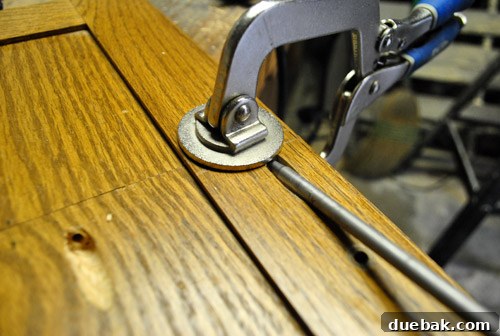 Cabinet door halves clamped and screwed together, with wood glue for a strong bond.