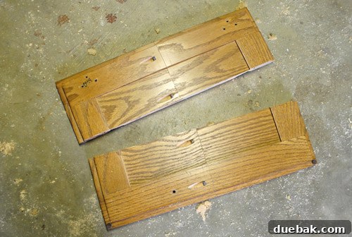 A custom-fitted cabinet door, assembled from multiple pieces to fit above the fridge.