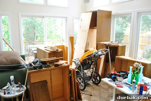 A sunroom in disarray, showing the reality of a DIY home that is often a messy workspace.
