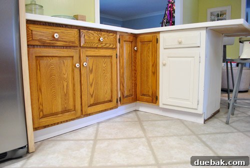 Newly installed baseboard serving as toe-kick around peninsula