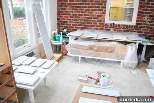 Kitchen cabinet priming in progress, showcasing the initial coat