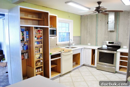 Another view of the kitchen cabinets with a uniform primer coat