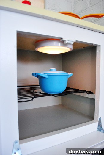 Play kitchen oven interior with tap light and wire rack