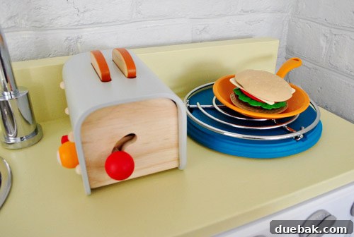 DIY hot plate for the play kitchen, made from a trivet and painted wood round
