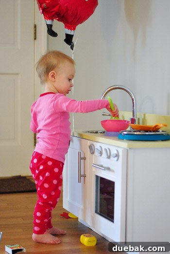 Clara enjoying her play kitchen, close up