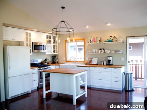 Newly installed IKEA cabinets, island, and countertop in the transformed kitchen