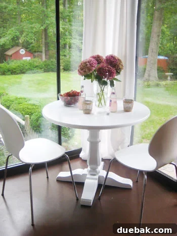sunroomphotostylistmagazinestyling Sunroom table styled with grapes, pink lemonade, and purple hydrangeas to create a lived-in feel