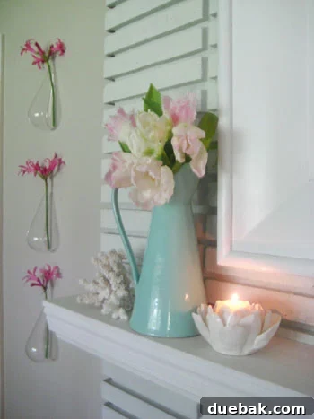 detailshotfireplacemantleproductstyling Close-up of a fireplace mantle styled with various floral arrangements and decor items